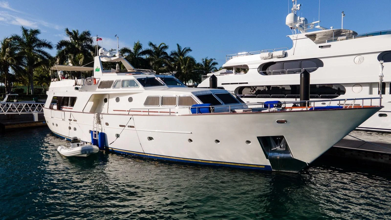 A classic yacht is docked in a serene marina, showcasing its elegant lines and spacious deck. aboard SISISI Yacht for Sale