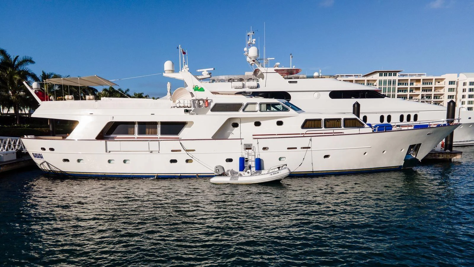A luxurious yacht is docked at a marina, showcasing its elegant design and spacious decks. aboard SISISI Yacht for Sale