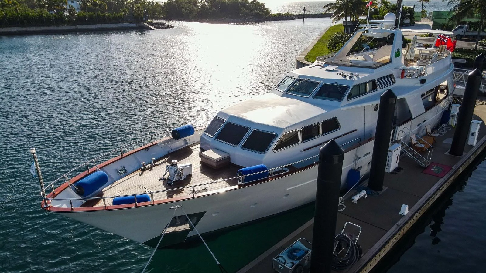 A luxurious yacht docked at a serene marina, showcasing its sleek design and spacious deck. aboard SISISI Yacht for Sale