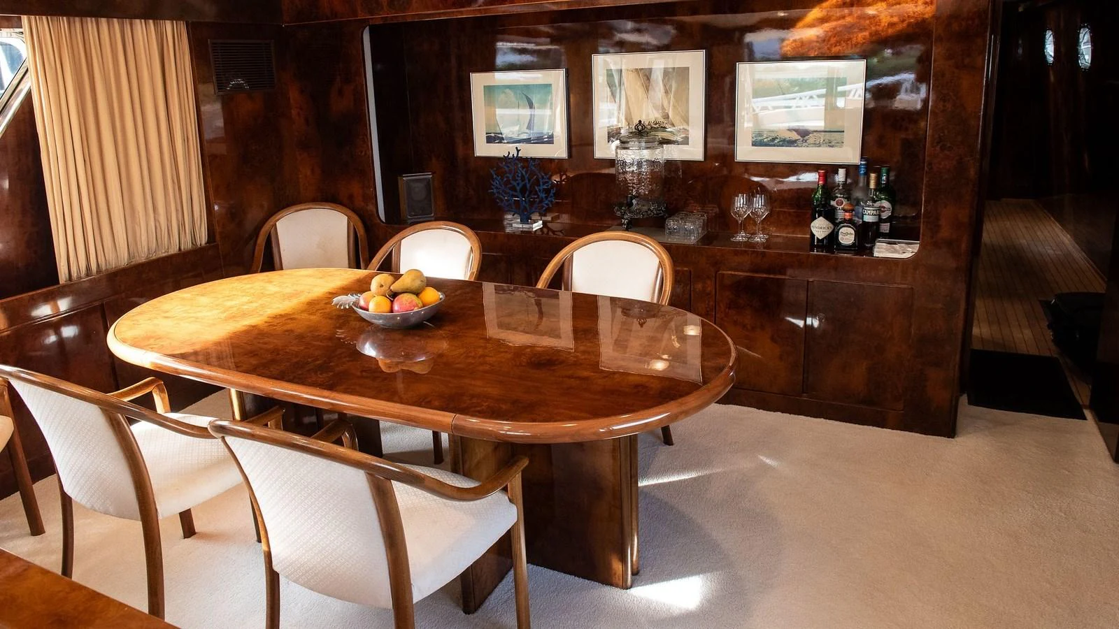 The yacht's dining area features a polished wooden table with elegant seating and tasteful decor. aboard SISISI Yacht for Sale