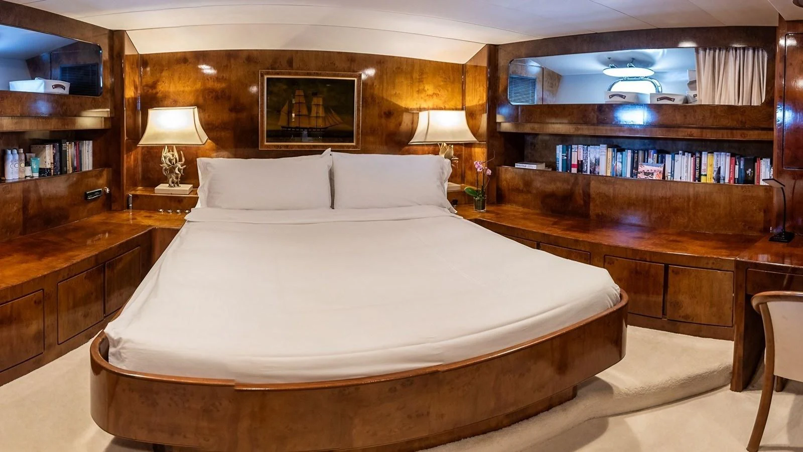 The master stateroom features a luxurious bed with rich wooden furnishings and ample storage space. aboard SISISI Yacht for Sale