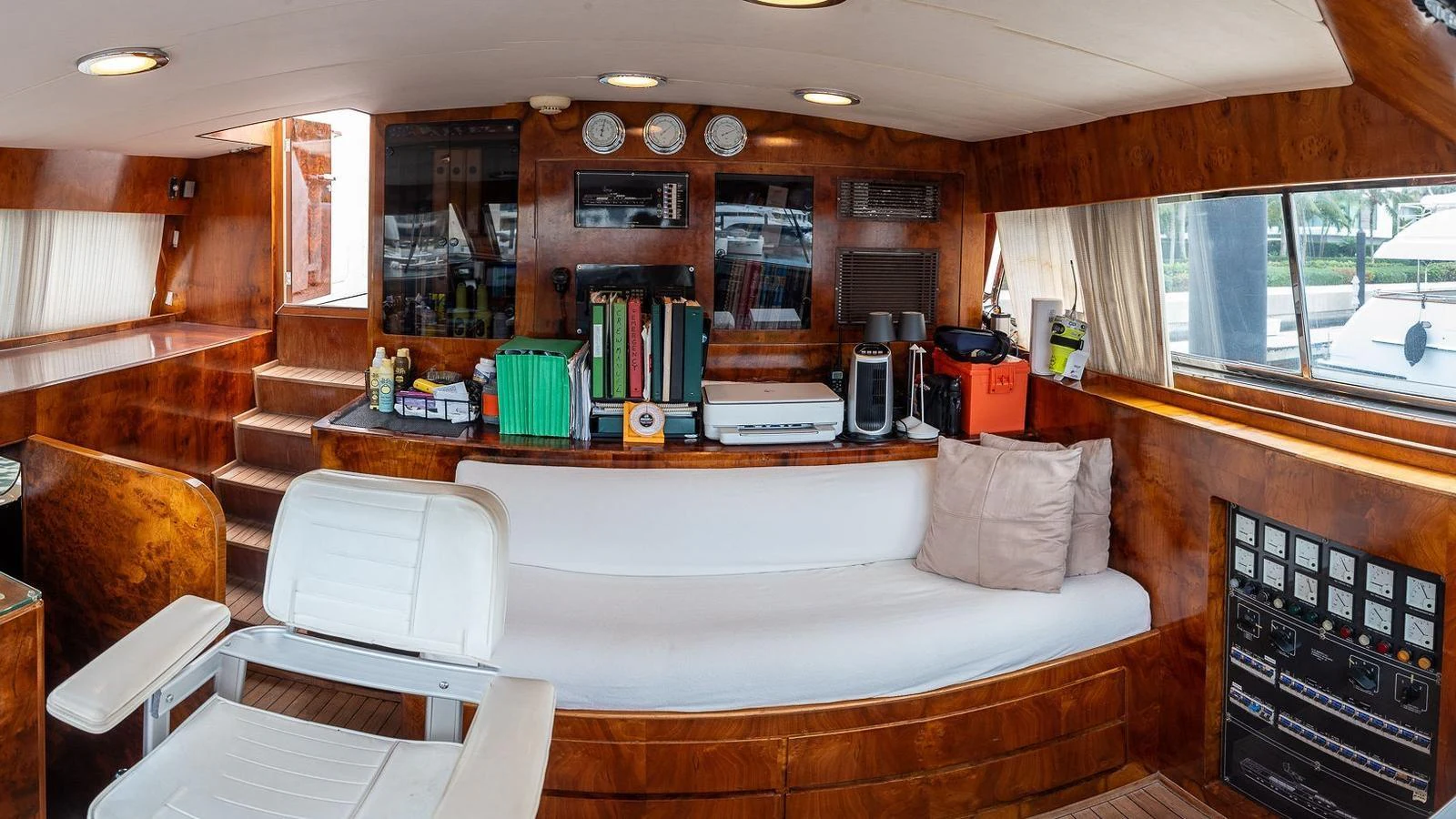 The salon features a cozy seating area with rich wood paneling and ample natural light. aboard SISISI Yacht for Sale