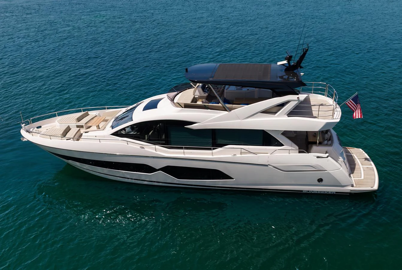 A sleek and modern yacht glides gracefully on the open water, showcasing its elegant design and spacious decks. aboard BAZINGA Yacht for Sale