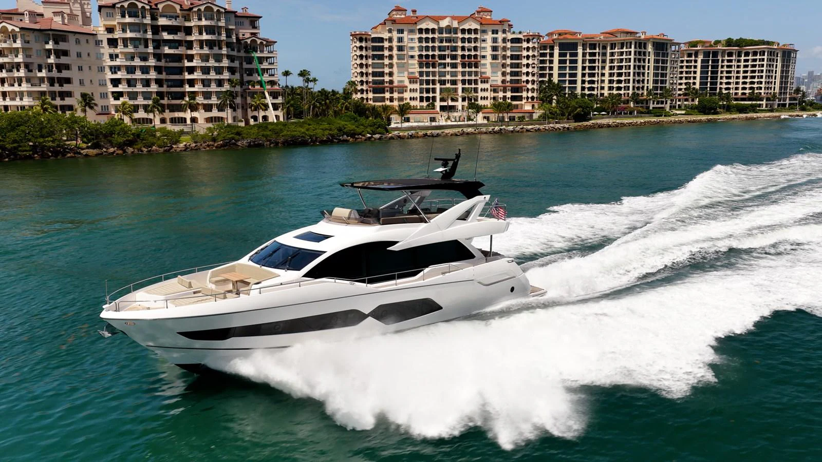 A sleek yacht cruises swiftly through clear waters, showcasing its modern design and luxurious amenities. aboard BAZINGA Yacht for Sale