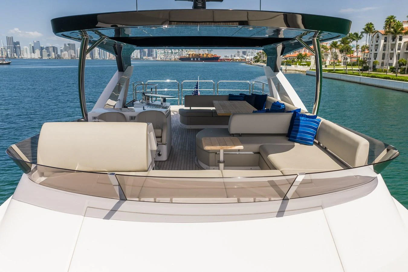 The flybridge offers a spacious and luxurious outdoor seating area with stunning views of the water and city skyline. aboard BAZINGA Yacht for Sale