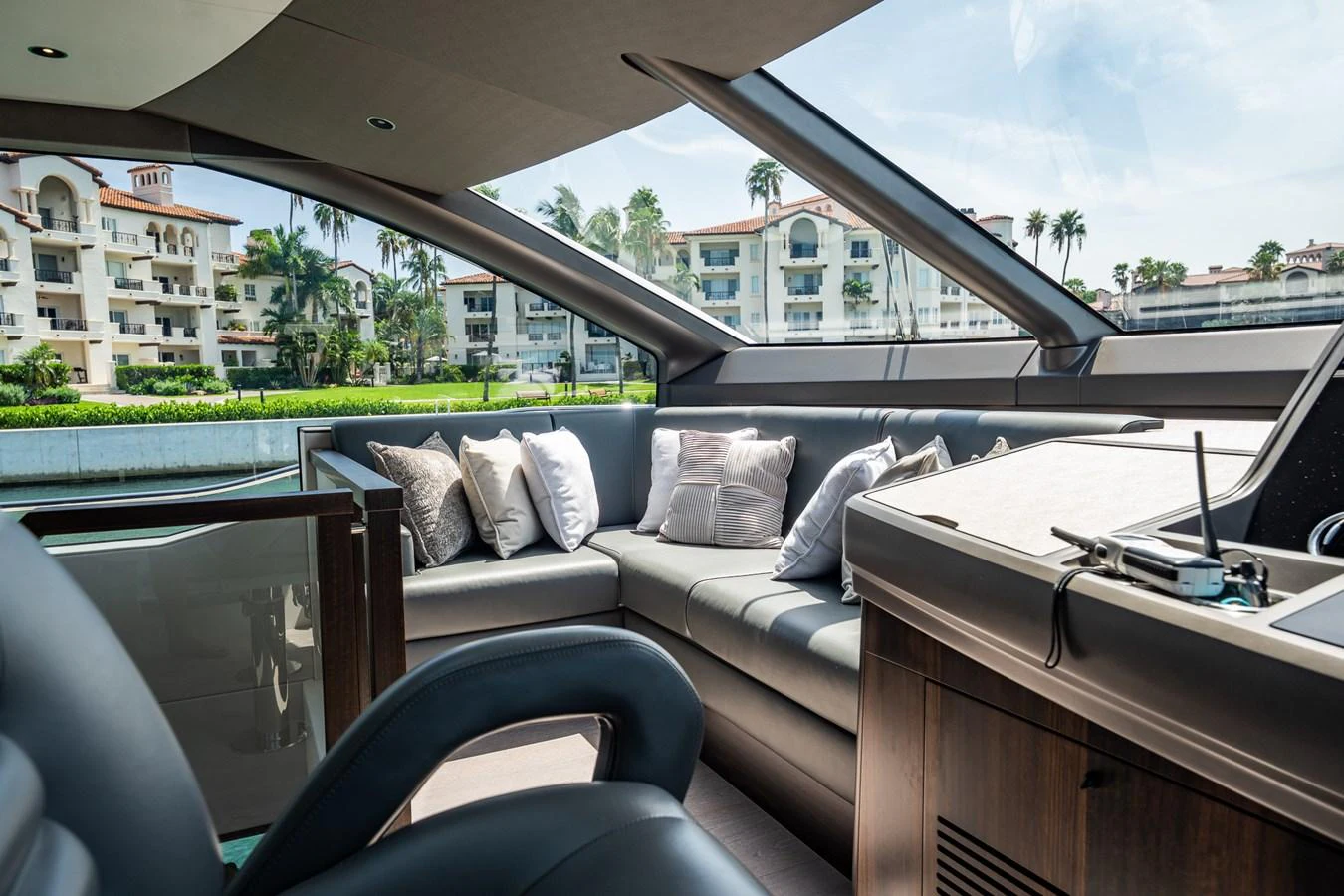 The yacht's salon features a luxurious seating area with plush cushions and panoramic windows offering scenic views. aboard BAZINGA Yacht for Sale