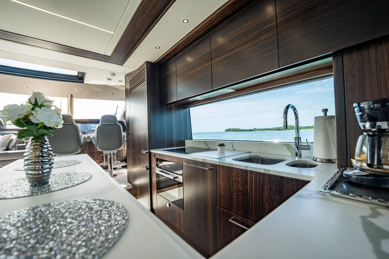 The yacht's galley features modern appliances and a stunning view through large windows. aboard BAZINGA Yacht for Sale