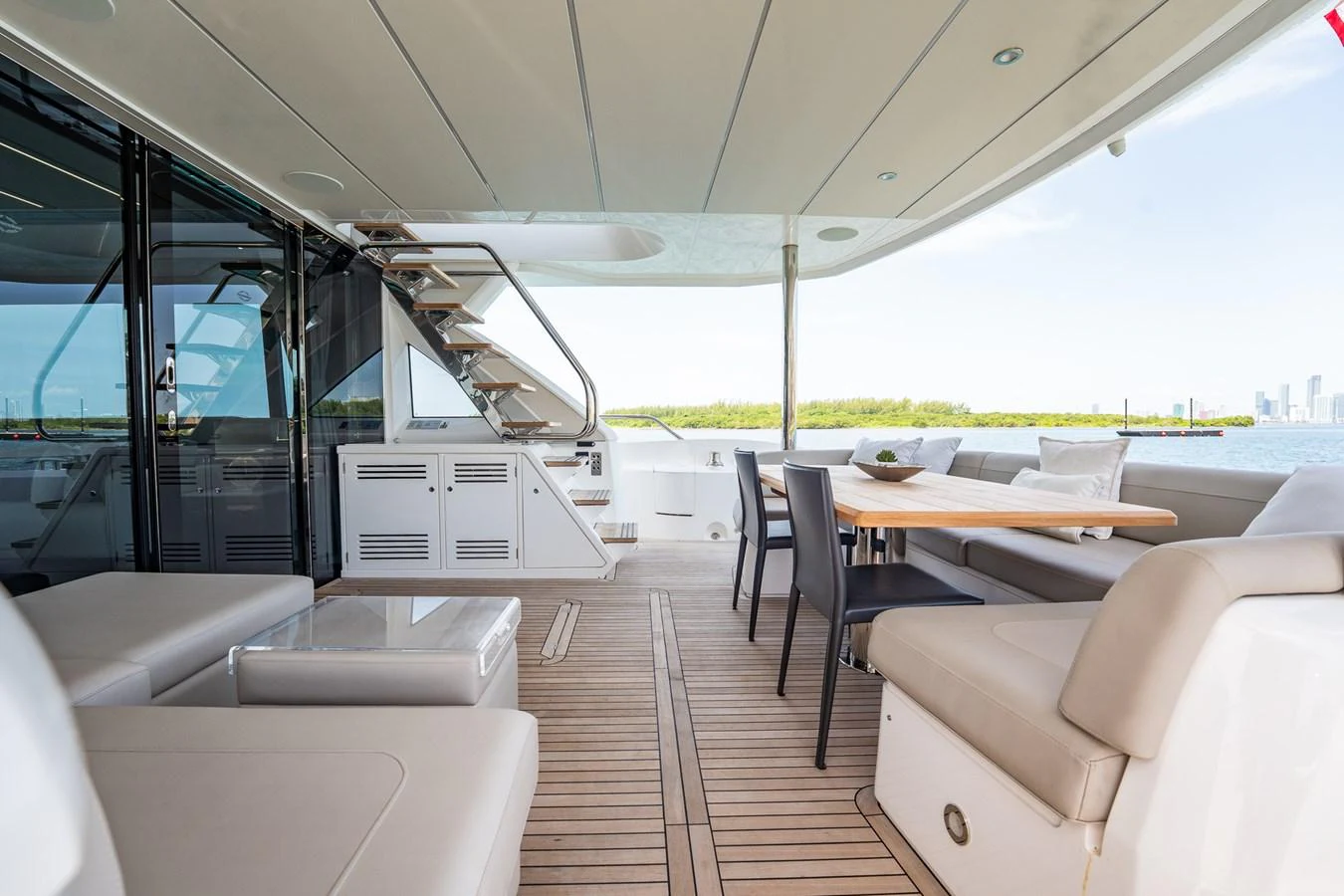 The aft deck offers a spacious and inviting area for relaxation and dining with a scenic view. aboard BAZINGA Yacht for Sale
