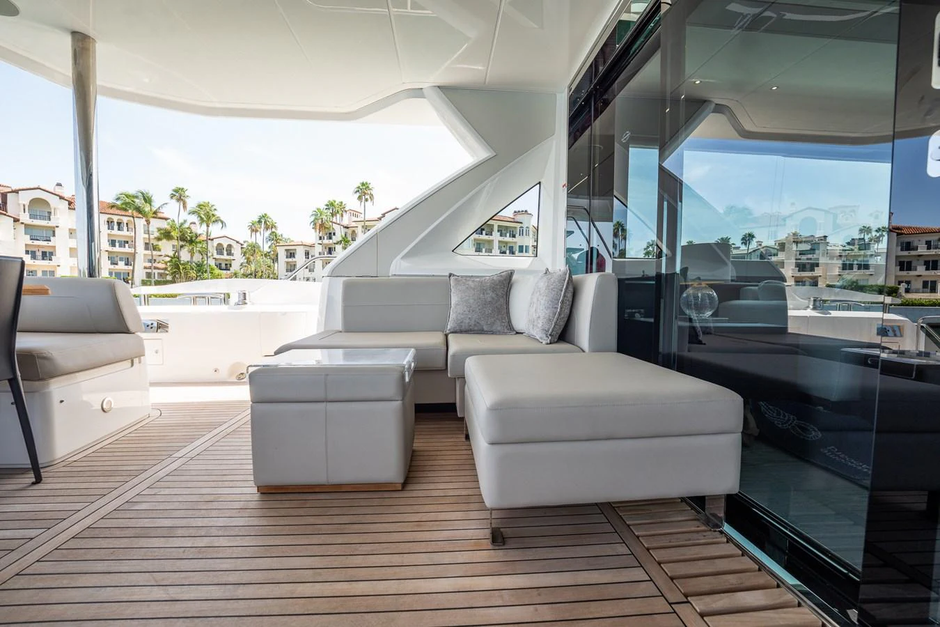 The aft deck features a comfortable seating area with plush cushions and a sleek, modern design. aboard BAZINGA Yacht for Sale