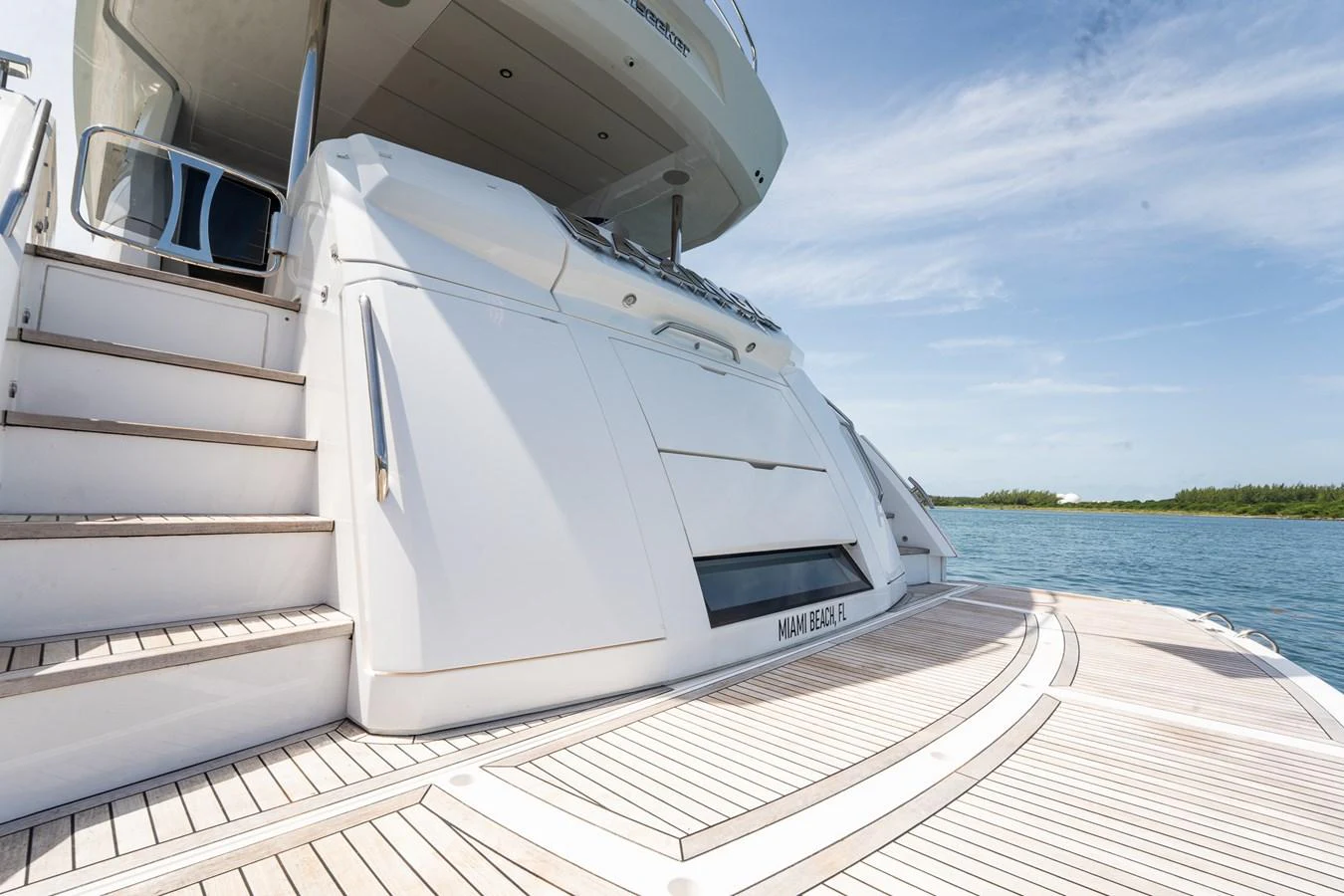 The yacht's aft deck features elegant teak flooring and a sleek, modern design. aboard BAZINGA Yacht for Sale