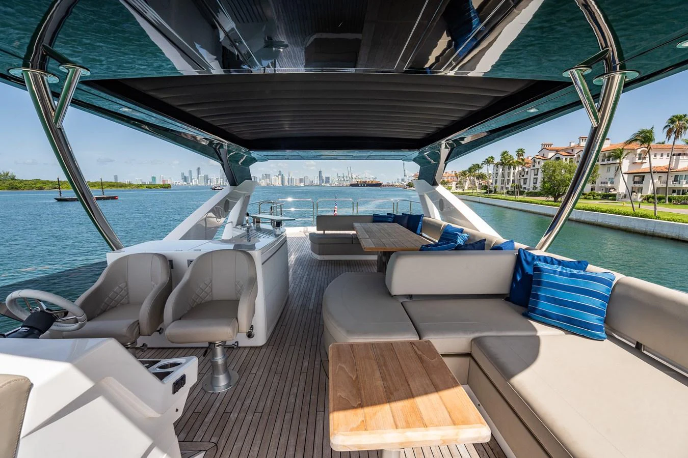 The flybridge offers a spacious seating area with a stunning view of the water and city skyline. aboard BAZINGA Yacht for Sale