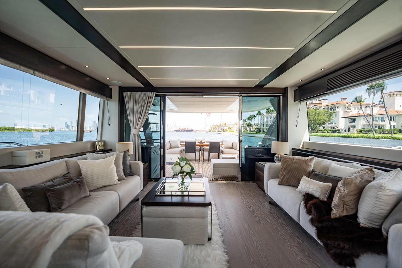 The yacht's salon offers a spacious and luxurious seating area with large windows providing stunning views. aboard BAZINGA Yacht for Sale