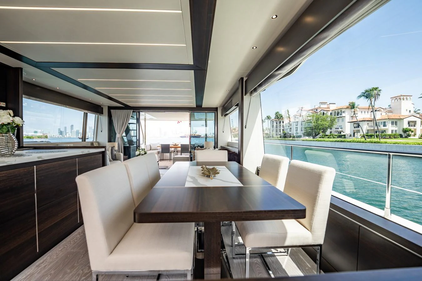 The yacht's dining area offers a luxurious and spacious setting with panoramic views. aboard BAZINGA Yacht for Sale