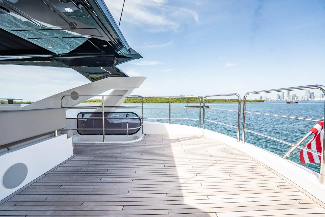 The aft deck offers a spacious and inviting area with stunning views of the water and skyline. aboard BAZINGA Yacht for Sale
