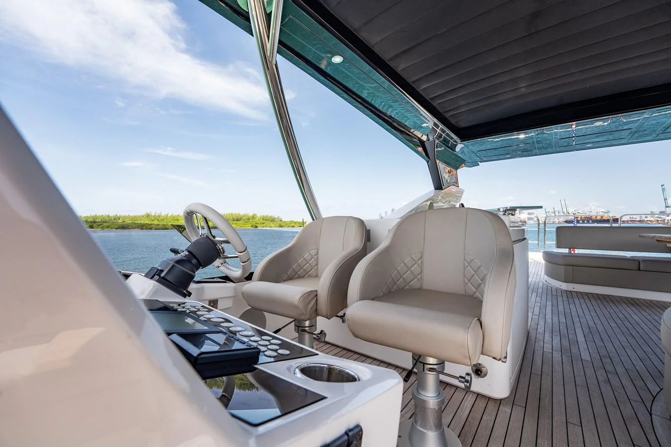 The helm area features comfortable seating with a view of the water. aboard BAZINGA Yacht for Sale