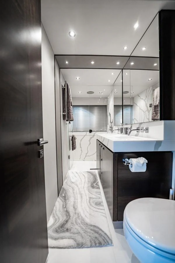 A sleek and modern yacht bathroom with elegant fixtures and a stylish design. aboard BAZINGA Yacht for Sale