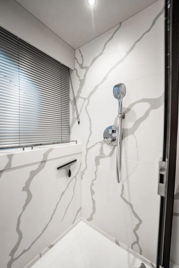 A sleek and modern yacht bathroom with a minimalist design. aboard BAZINGA Yacht for Sale