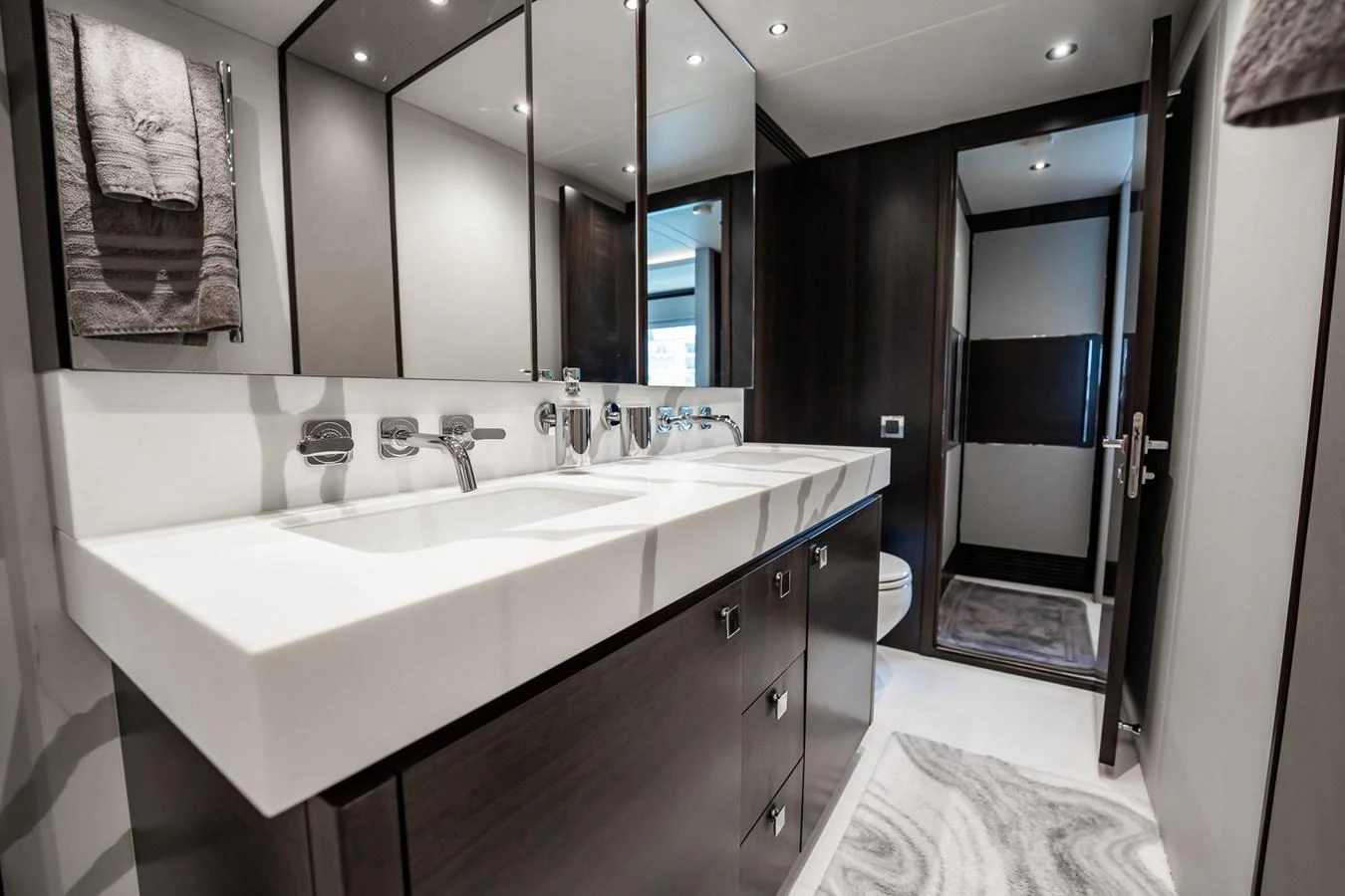 The yacht's bathroom features a sleek, modern design with a spacious vanity and elegant fixtures. aboard BAZINGA Yacht for Sale