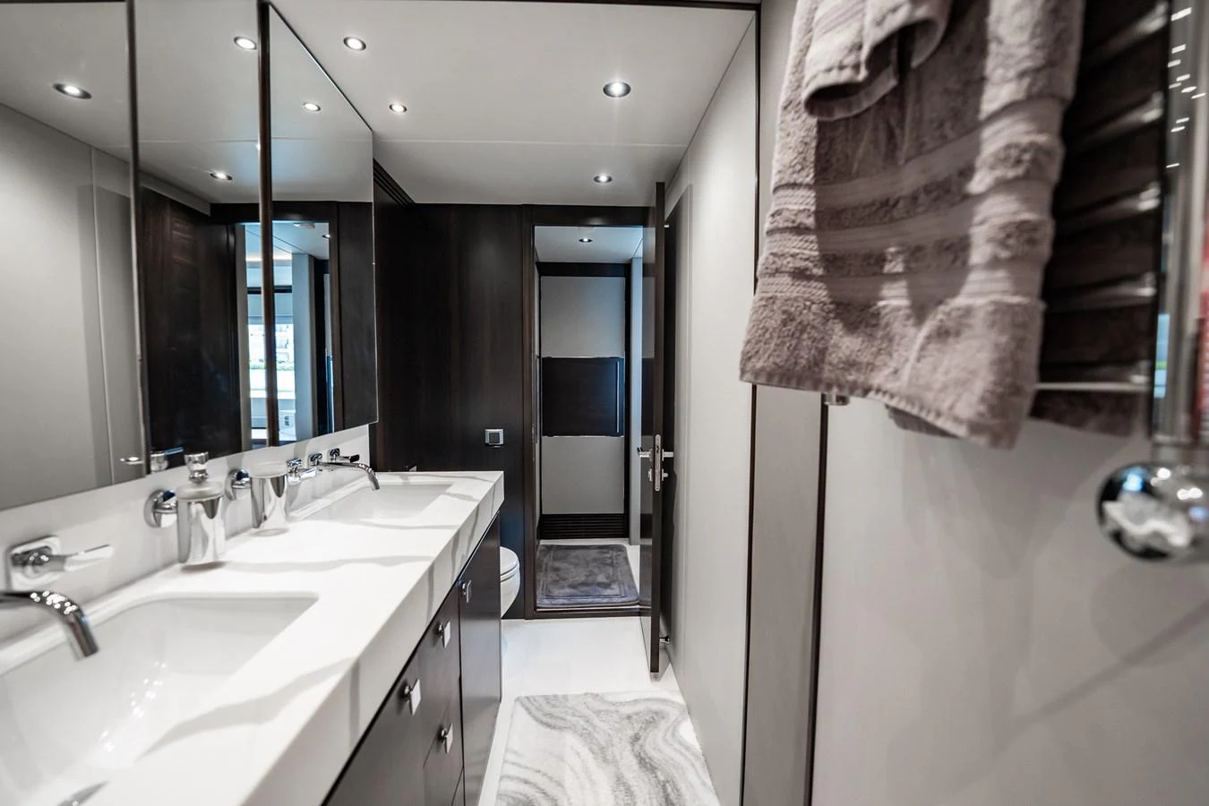 The yacht's bathroom features a sleek, modern design with double sinks and luxurious fixtures. aboard BAZINGA Yacht for Sale