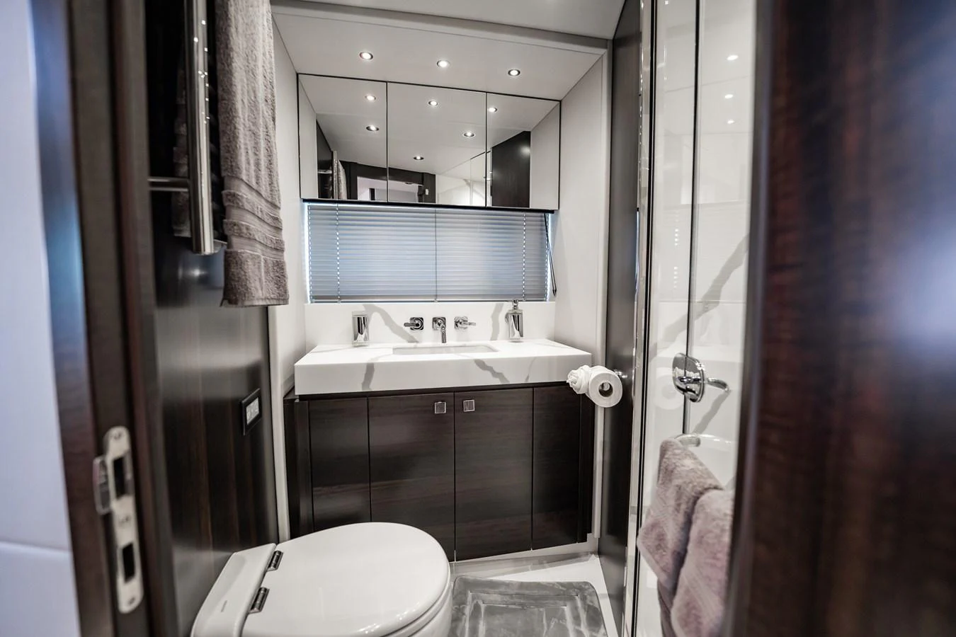 A sleek and modern yacht bathroom with contemporary fixtures and elegant finishes. aboard BAZINGA Yacht for Sale