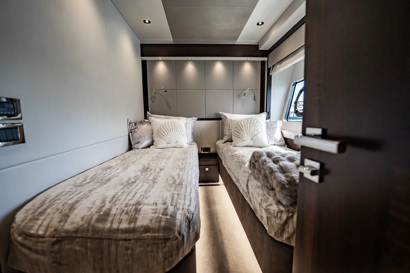 The twin stateroom offers a cozy and luxurious sleeping area with two single beds and elegant decor. aboard BAZINGA Yacht for Sale
