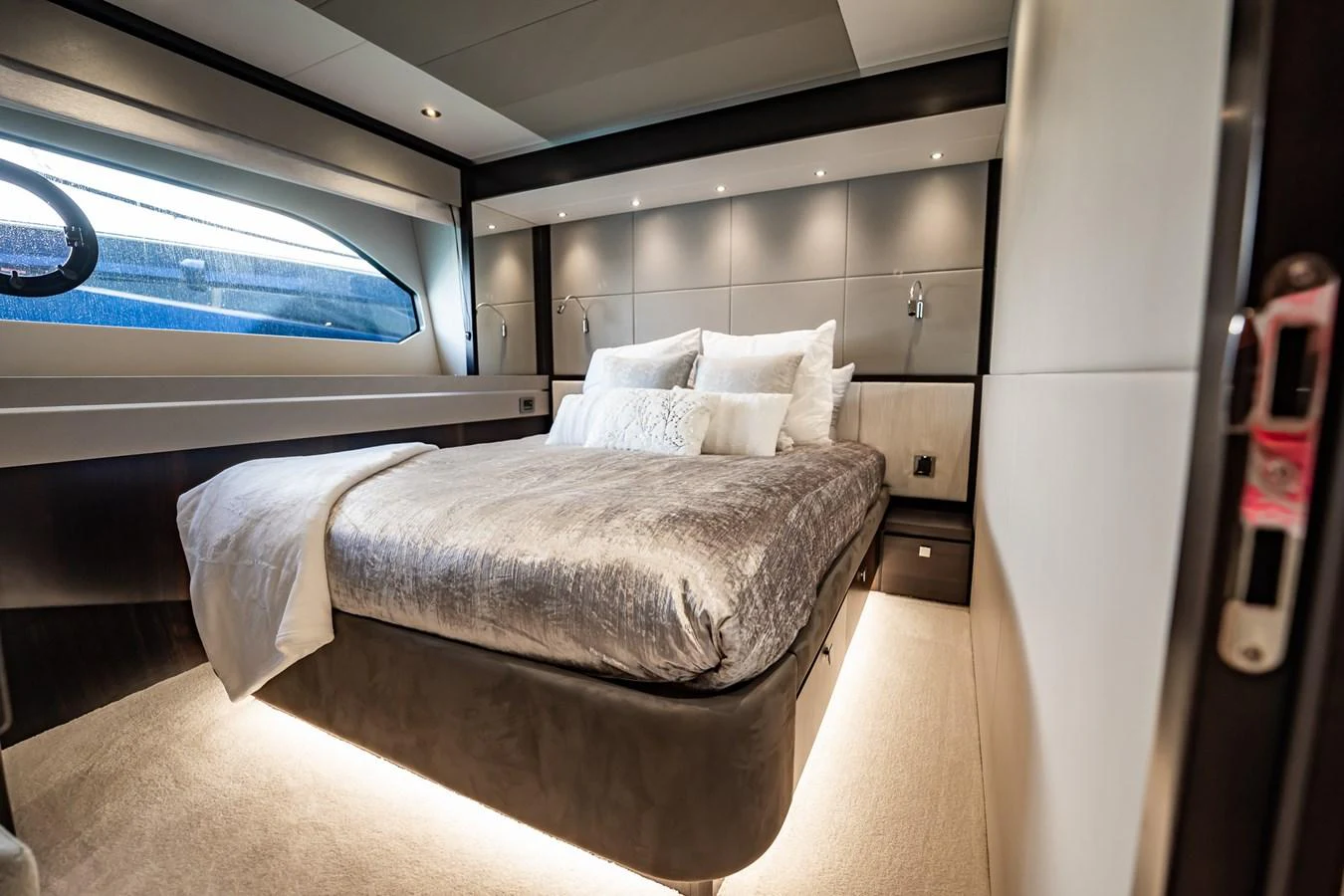 A luxurious stateroom with a plush bed and modern lighting. aboard BAZINGA Yacht for Sale