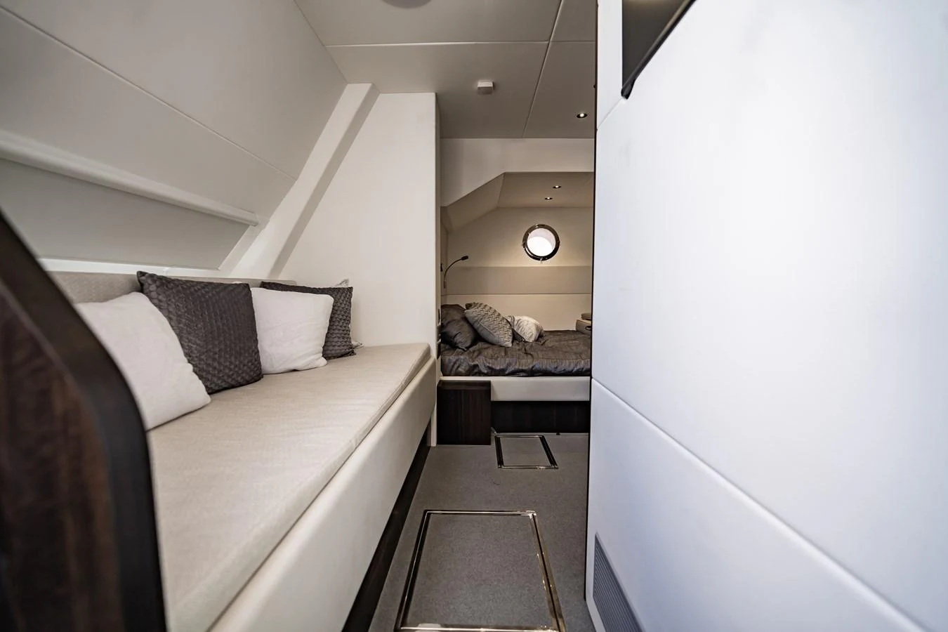 The cozy cabin features a comfortable seating area and a bed with soft linens. aboard BAZINGA Yacht for Sale