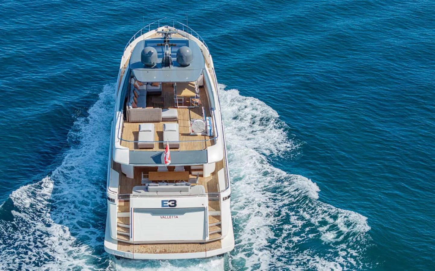 A luxurious yacht glides smoothly over the water, showcasing its elegant design and spacious deck. aboard E3 Yacht for Sale
