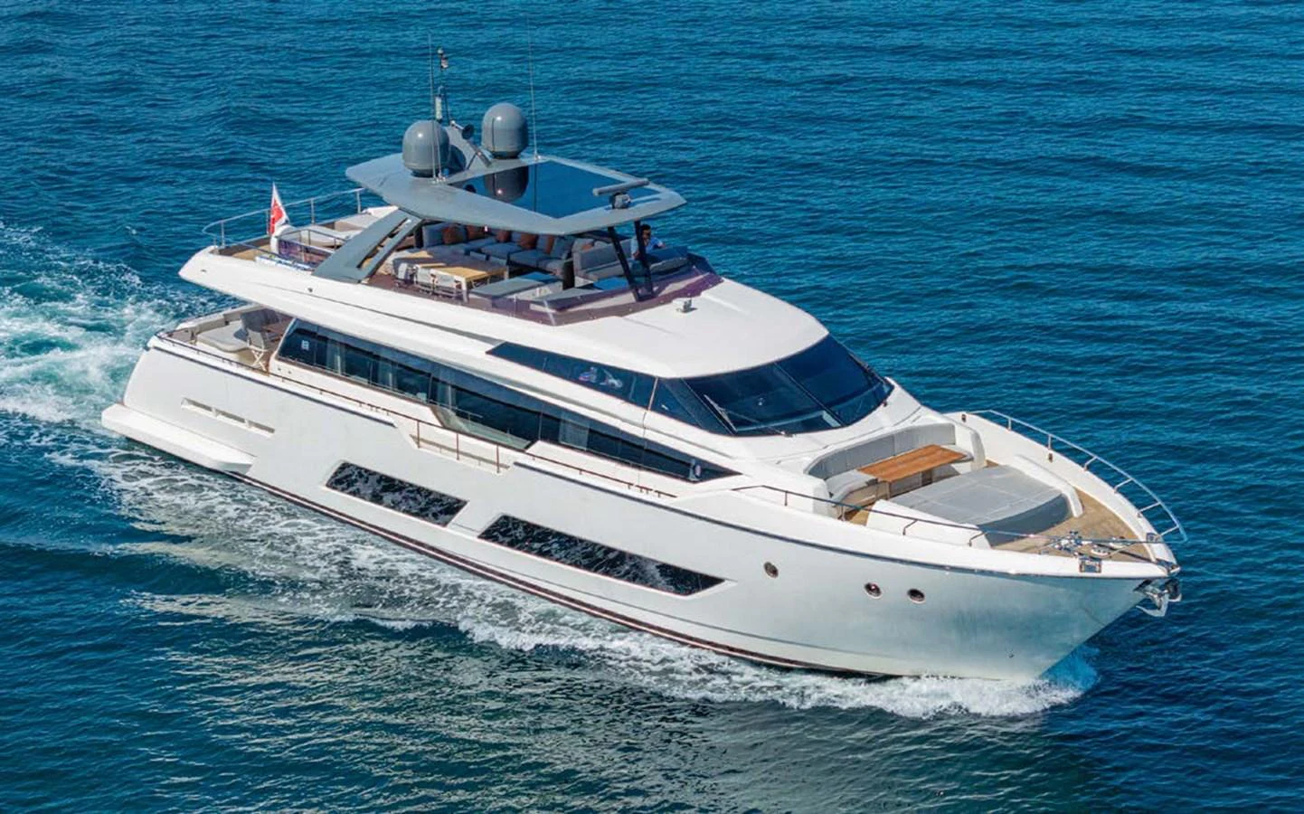 A sleek and modern yacht cruising through clear blue waters. aboard E3 Yacht for Sale