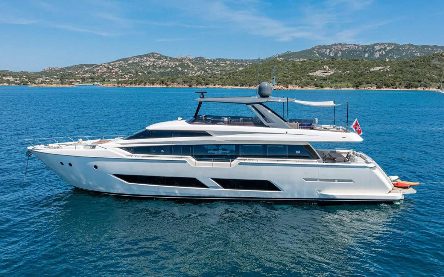 A sleek and modern yacht cruising on calm blue waters with a scenic coastal backdrop. aboard E3 Yacht for Sale