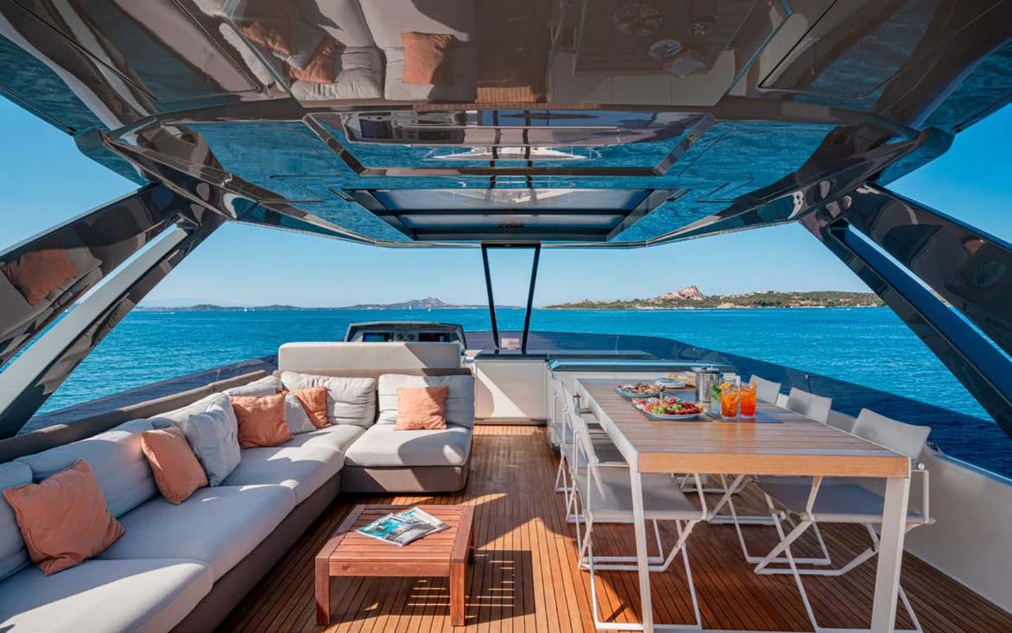The flybridge offers a luxurious outdoor living space with comfortable seating and a dining area, all under a sleek, modern canopy. aboard E3 Yacht for Sale