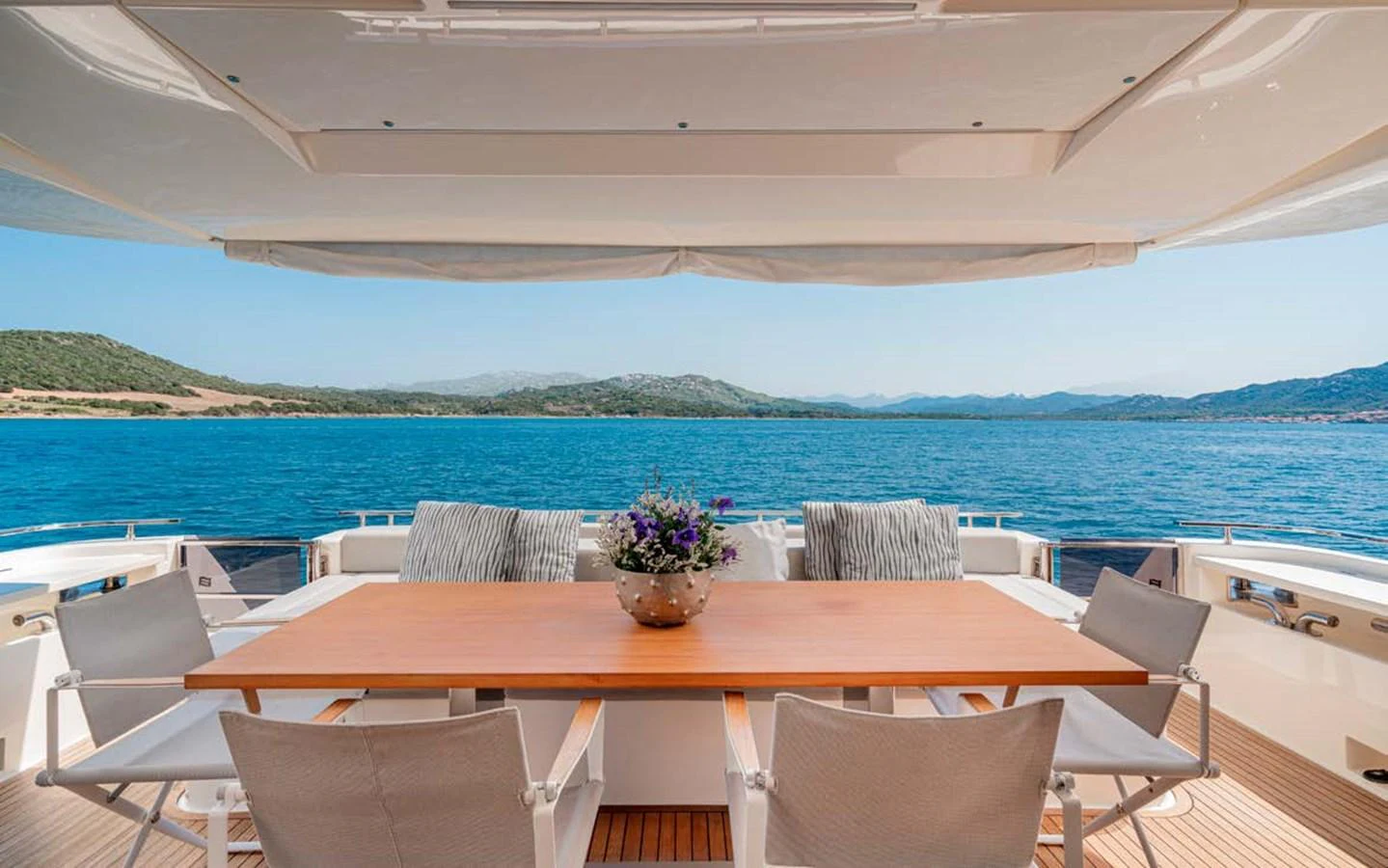 The aft deck offers a serene dining area with stunning ocean views. aboard E3 Yacht for Sale