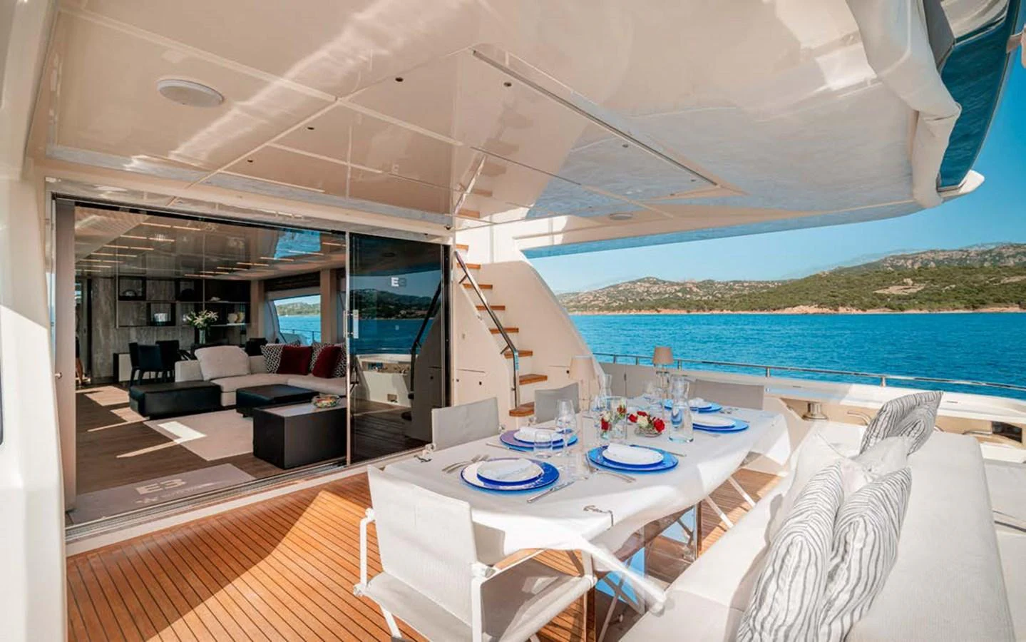 The aft deck features an elegant dining area with a stunning view of the sea. aboard E3 Yacht for Sale