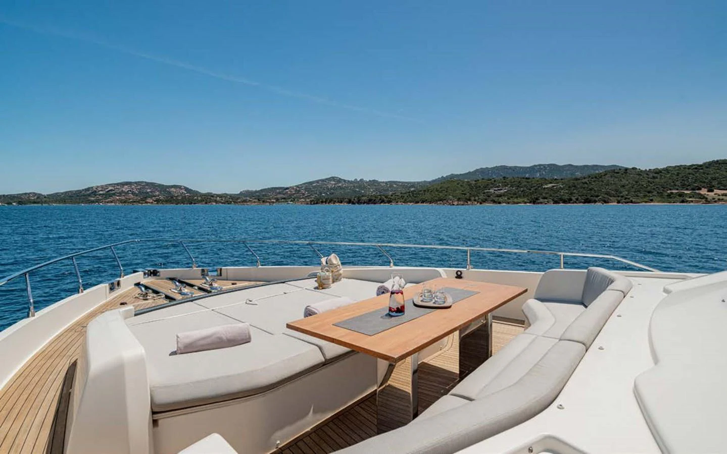 The foredeck features a spacious sunbathing area with comfortable seating and a table, perfect for enjoying the scenic views. aboard E3 Yacht for Sale