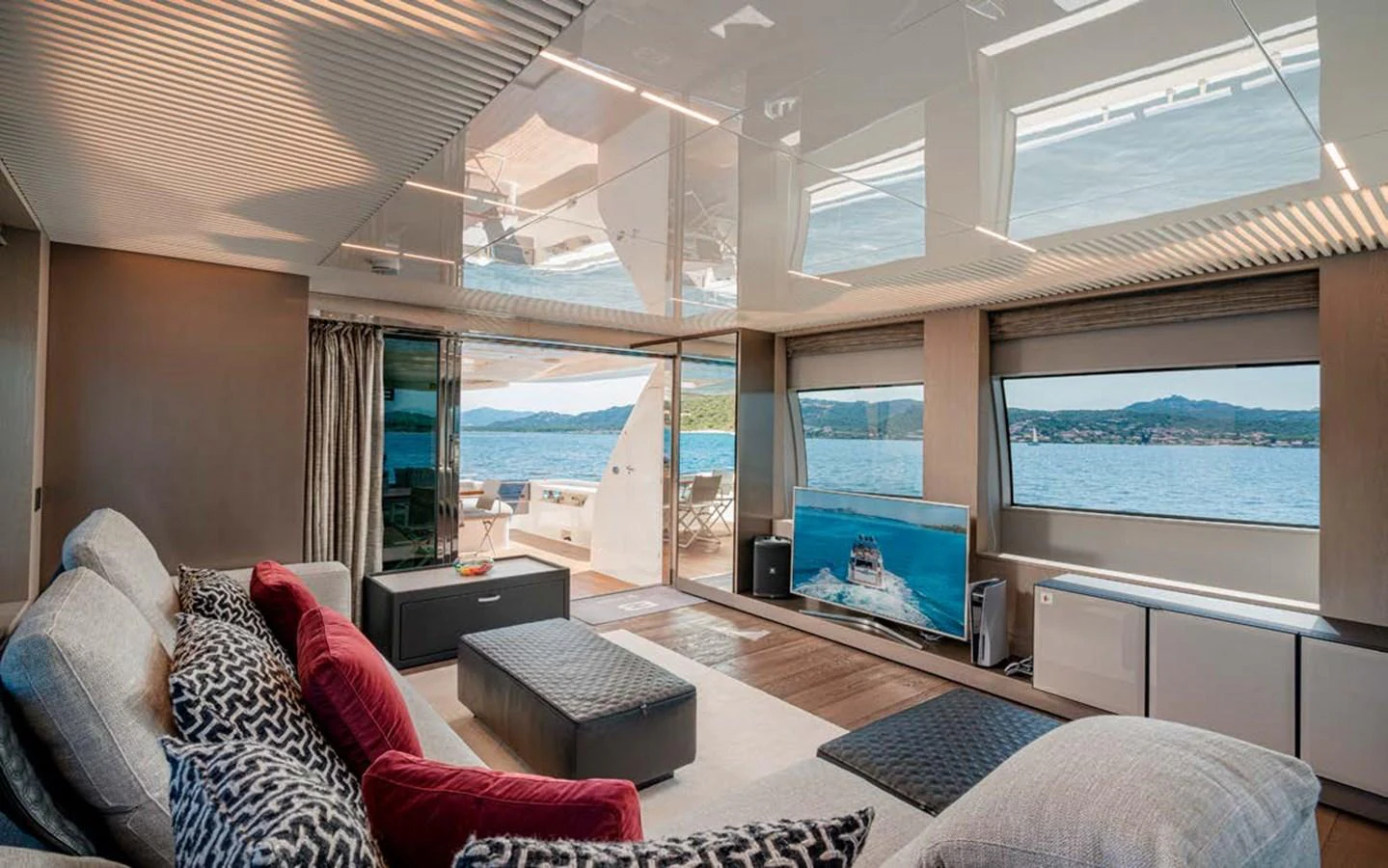 The salon offers a spacious and luxurious area with ample seating and large windows providing stunning views. aboard E3 Yacht for Sale