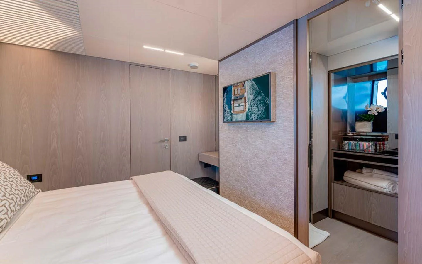 The guest stateroom features a comfortable bed and a private ensuite bathroom. aboard E3 Yacht for Sale