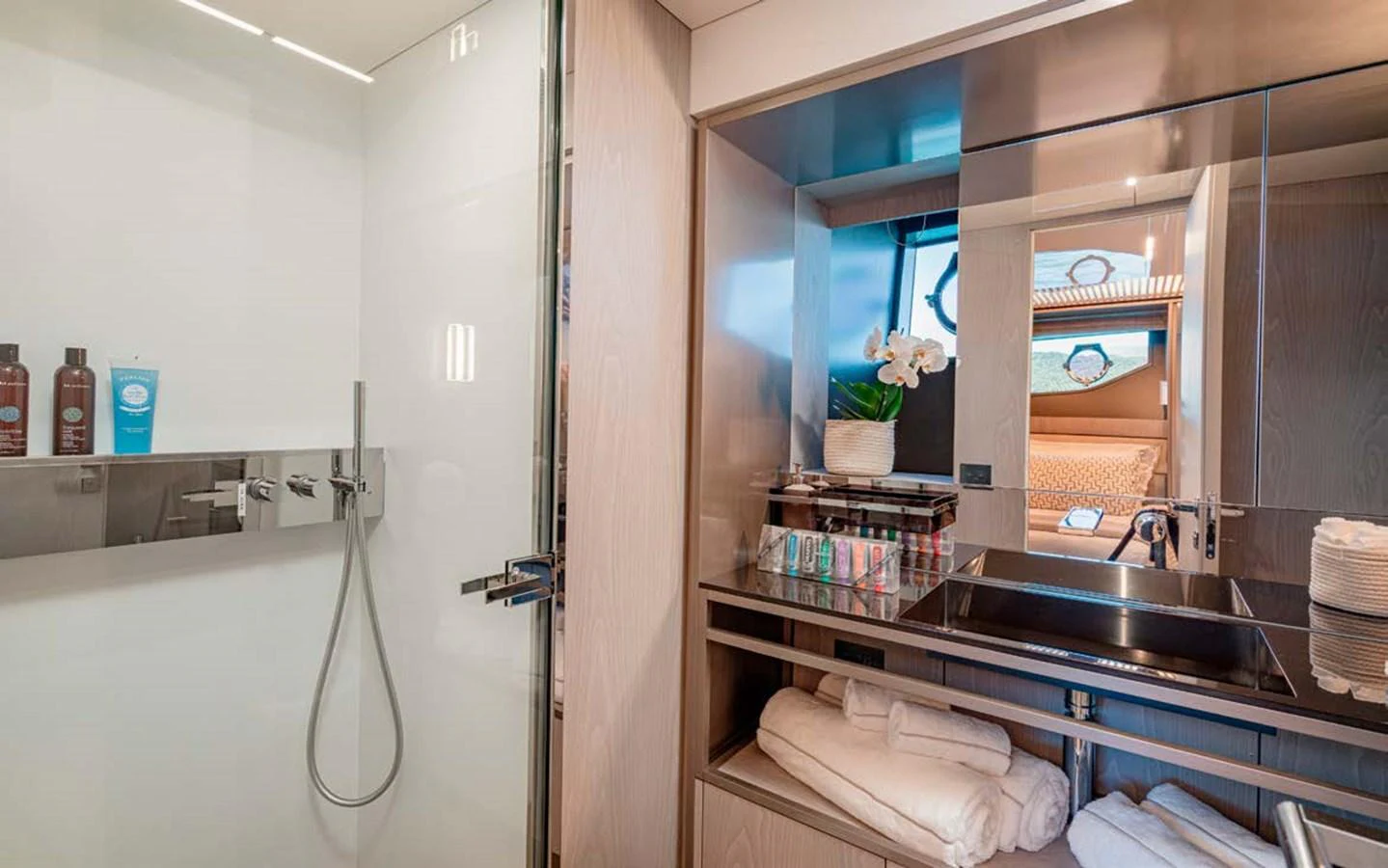 The yacht's bathroom features a sleek design with modern fixtures and ample storage. aboard E3 Yacht for Sale