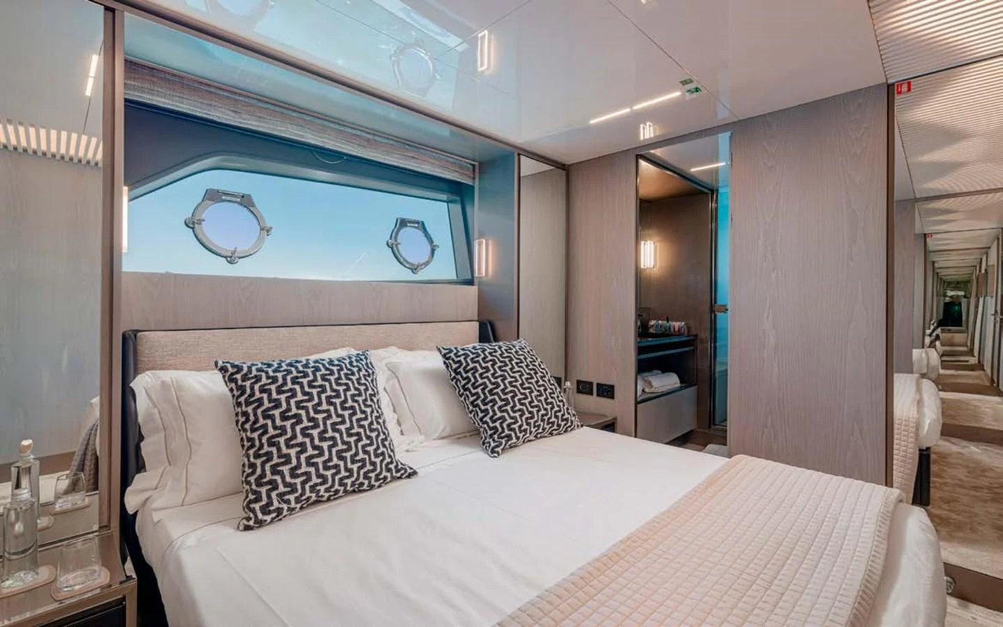 The stateroom features a luxurious bed with elegant bedding and modern decor. aboard E3 Yacht for Sale