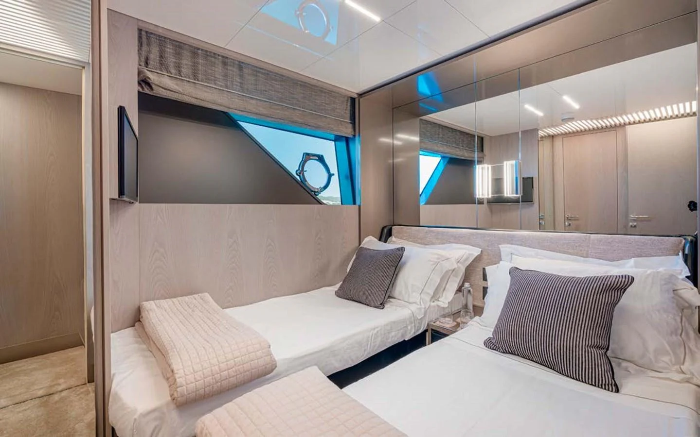 The guest stateroom features twin beds and modern decor, providing a comfortable and stylish retreat. aboard E3 Yacht for Sale