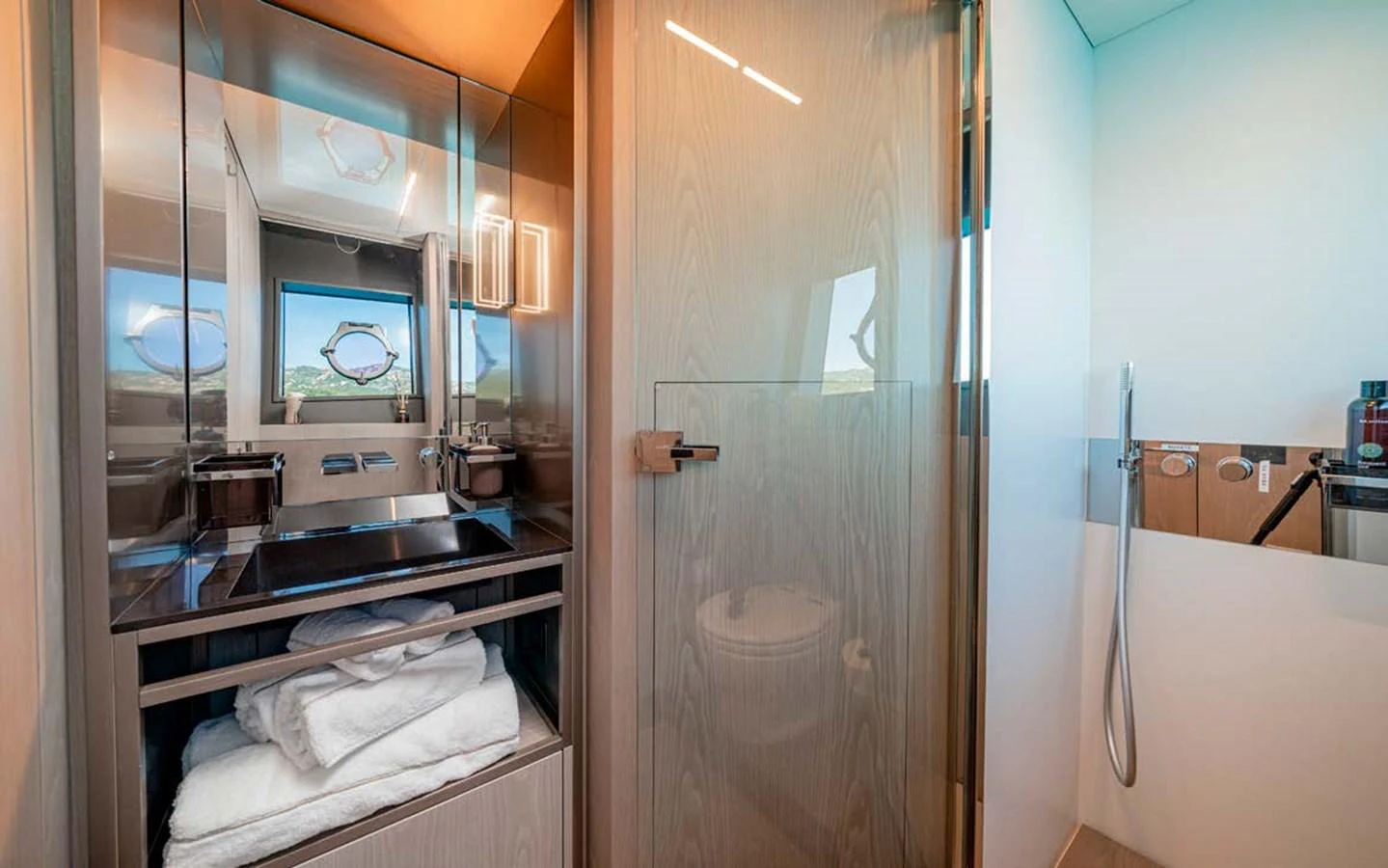 A modern yacht bathroom featuring sleek fixtures and ample storage space. aboard E3 Yacht for Sale