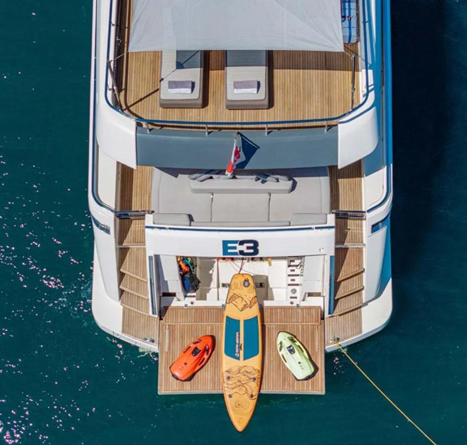 The aft deck of the yacht features a selection of water toys, including paddleboards and kayaks, ready for adventure. aboard E3 Yacht for Sale