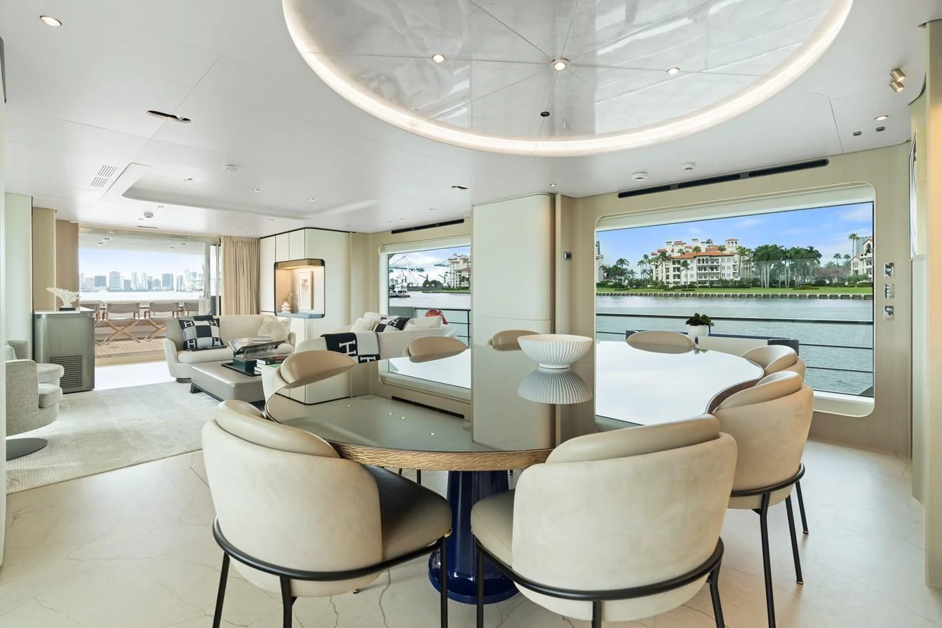 The yacht's dining area features a sleek, modern design with ample seating and large windows offering stunning water views. aboard AZIMUT GRANDE 32/23 Yacht for Sale