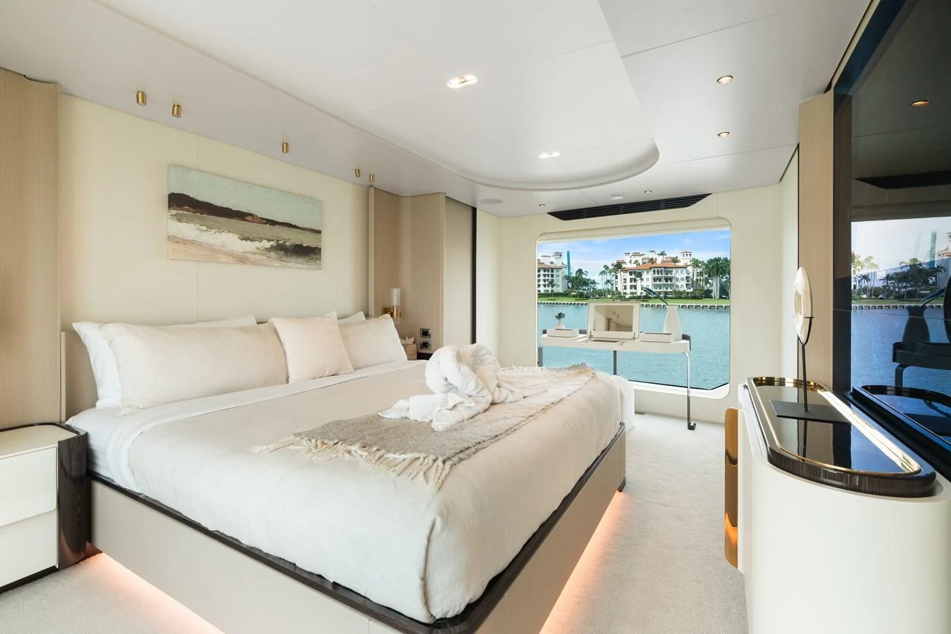 The master stateroom features a luxurious king-size bed with a stunning view of the water through large windows. aboard AZIMUT GRANDE 32/23 Yacht for Sale