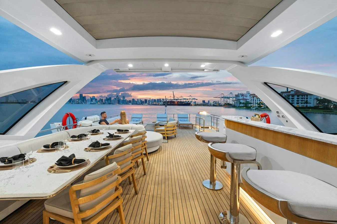 The flybridge offers a spacious dining and lounging area with stunning views of the city skyline. aboard AZIMUT GRANDE 32/23 Yacht for Sale