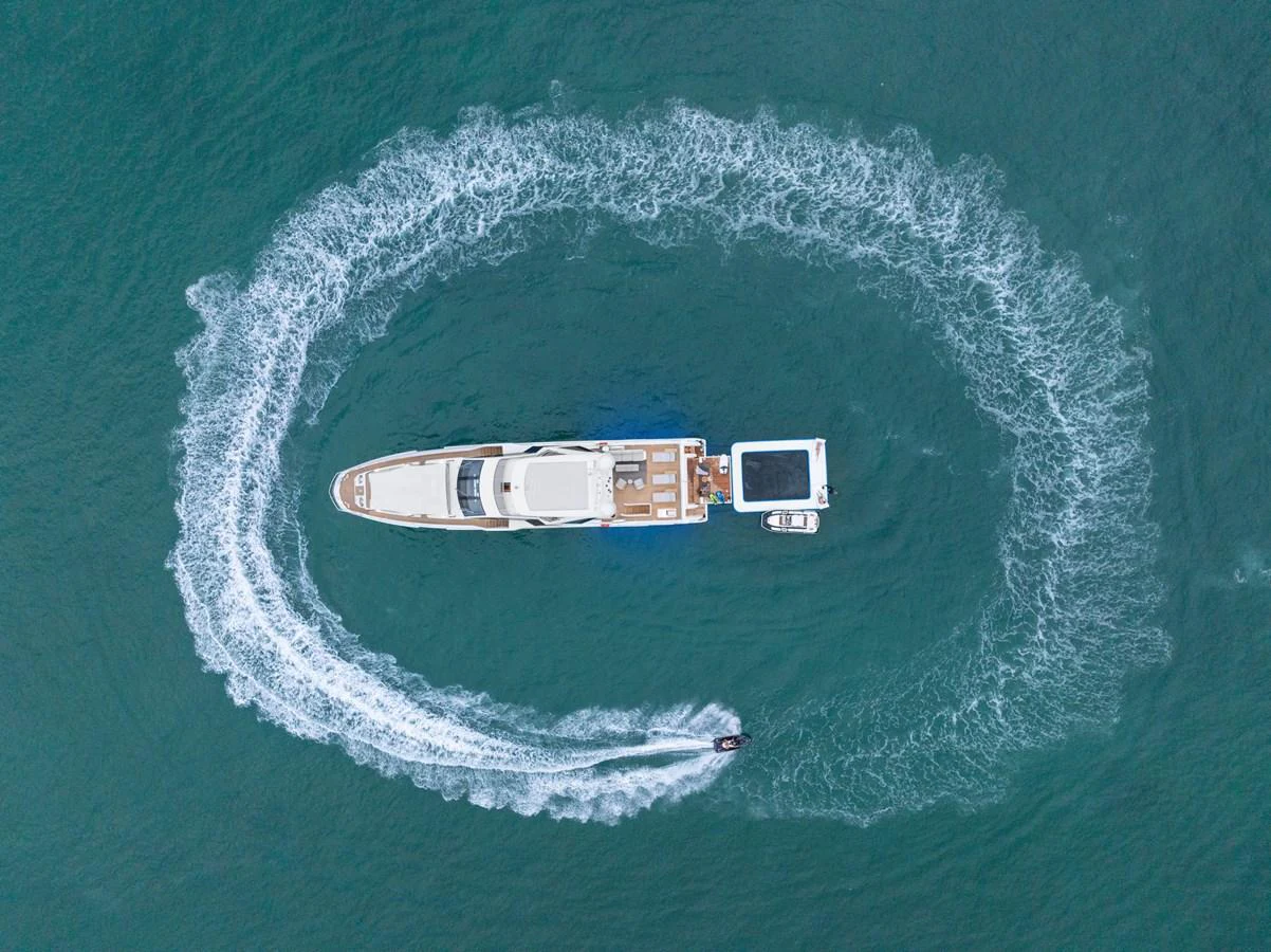 An aerial view of a yacht cruising on the water, leaving a circular wake pattern. aboard AZIMUT GRANDE 32/23 Yacht for Sale