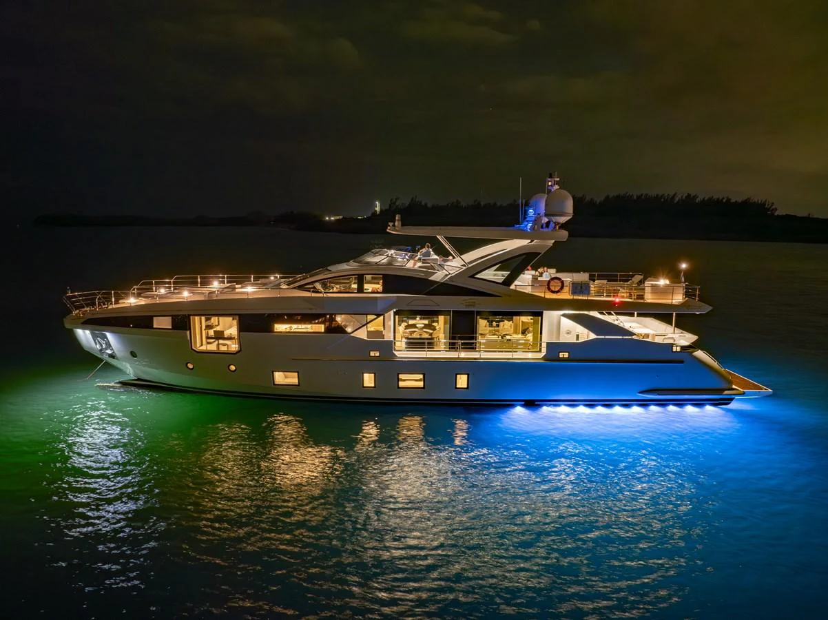 A sleek and modern yacht illuminated beautifully against the night sky, showcasing its elegant design and luxurious features. aboard AZIMUT GRANDE 32/23 Yacht for Sale