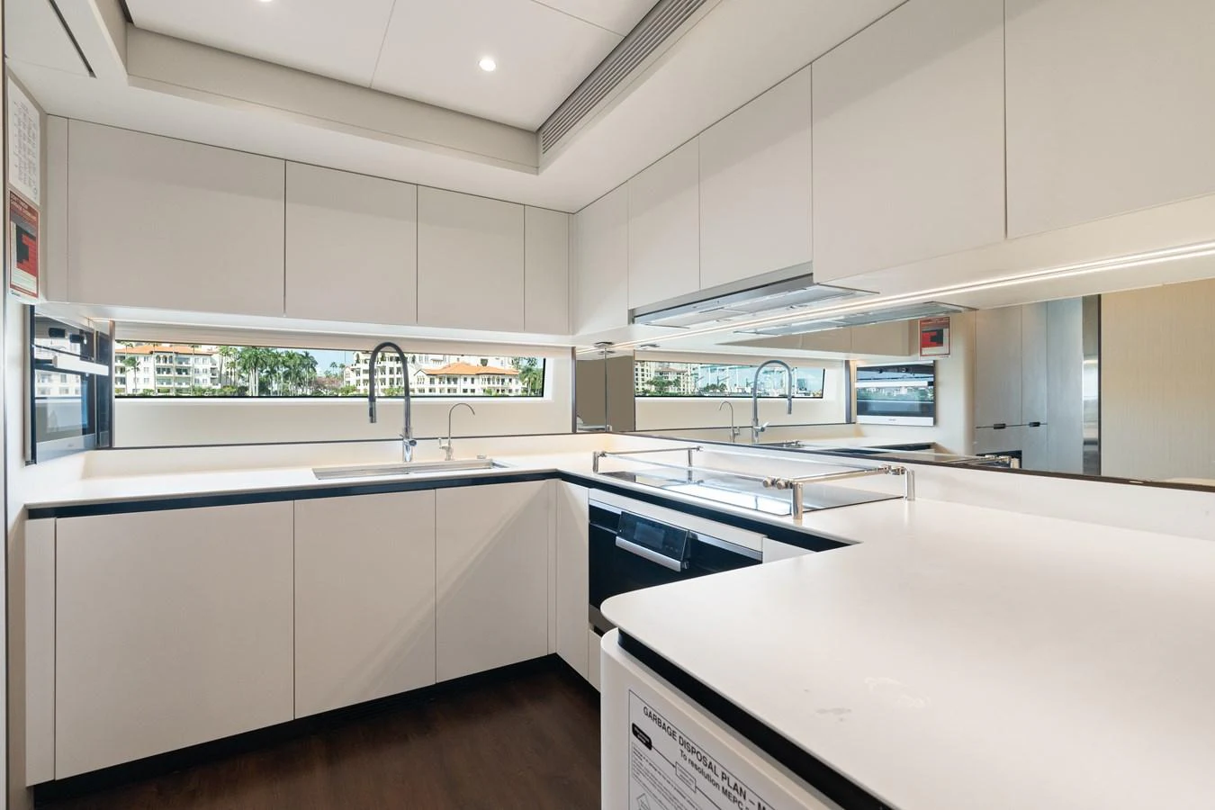 The yacht's galley features sleek, modern cabinetry and high-end appliances, creating a bright and functional space for culinary endeavors. aboard AZIMUT GRANDE 32/23 Yacht for Sale