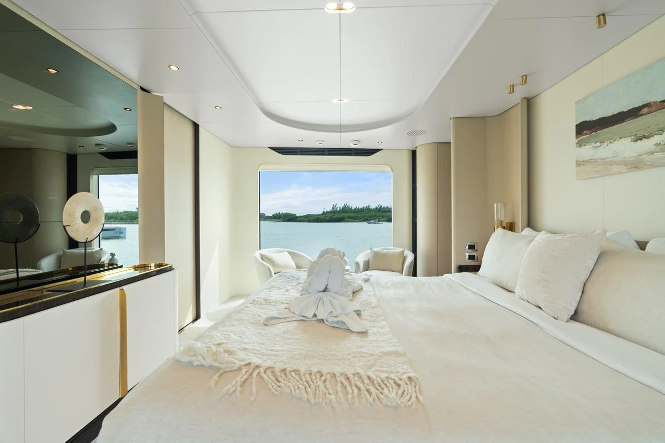 The master stateroom offers a serene retreat with a large bed and a picturesque view of the water. aboard AZIMUT GRANDE 32/23 Yacht for Sale