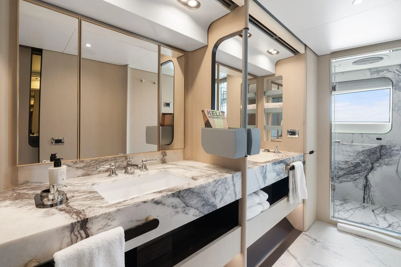 The yacht's bathroom features a luxurious marble countertop with dual sinks and a spacious shower area. aboard AZIMUT GRANDE 32/23 Yacht for Sale