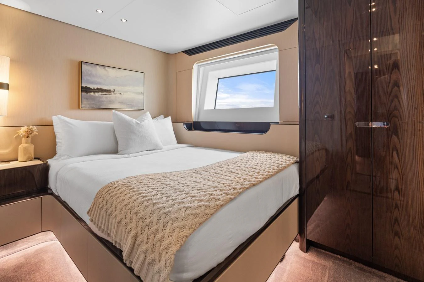 A cozy stateroom featuring a large bed, modern decor, and a window with a view of the sea. aboard AZIMUT GRANDE 32/23 Yacht for Sale
